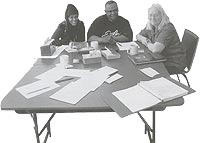 graphic - Three people working at a table